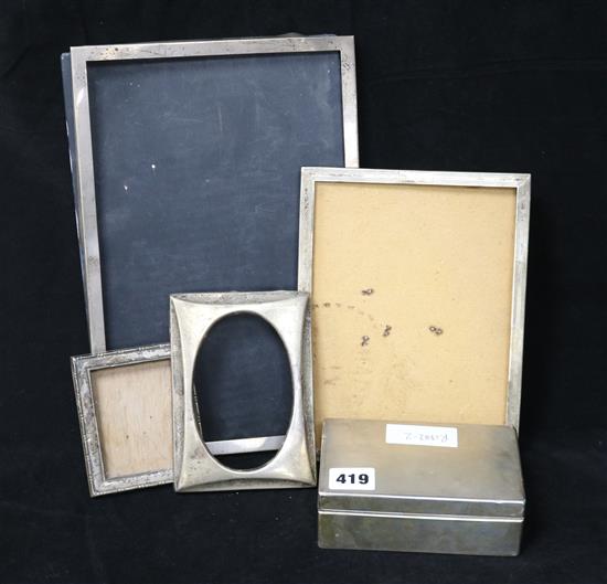 Four assorted silver photograph frames and a silver cigarette box.